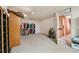 Finished basement area with door to secondary room and open clothing storage at 5525 Tallantworth Trl, Cumming, GA 30040