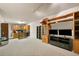 Finished basement space with shelving and storage solutions and a dedicated television area at 5525 Tallantworth Trl, Cumming, GA 30040