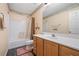 Bathroom featuring a single sink vanity, toilet, and tub with shower at 5525 Tallantworth Trl, Cumming, GA 30040