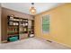 Bedroom with neutral colored walls, window with blinds, and a built-in bookshelf at 5525 Tallantworth Trl, Cumming, GA 30040