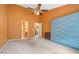 Spacious primary bedroom with a ceiling fan and a doorway that leads to the bath at 5525 Tallantworth Trl, Cumming, GA 30040