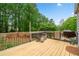 This outdoor deck with wooded views is perfect for grilling, relaxing, and entertaining guests at 5525 Tallantworth Trl, Cumming, GA 30040