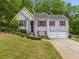 Charming gray split level home with red shutters and well-maintained landscaping at 5525 Tallantworth Trl, Cumming, GA 30040