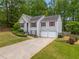 Charming gray split level home with red shutters and well-maintained landscaping at 5525 Tallantworth Trl, Cumming, GA 30040