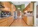 Well-lit kitchen with tiled floors, and wooden cabinets at 5525 Tallantworth Trl, Cumming, GA 30040