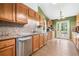 Functional kitchen with stainless steel appliances, tile backsplash and tile flooring at 5525 Tallantworth Trl, Cumming, GA 30040