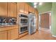 Spacious kitchen with stainless steel appliances, tile backsplash and tile flooring at 5525 Tallantworth Trl, Cumming, GA 30040