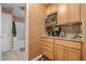 Features of the kitchenette include wood cabinets, sink, microwave, and adjacent full bathroom at 5525 Tallantworth Trl, Cumming, GA 30040
