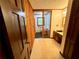 Bathroom featuring wood paneling, carpet flooring, and a doorway into the toilet and tub area at 880 Havenridge Dr, Conyers, GA 30094