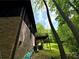 Exterior angle of home with a wooden deck and large trees in the background at 880 Havenridge Dr, Conyers, GA 30094
