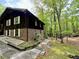 Charming home with brick and wood exterior, surrounded by lush greenery and mature trees at 880 Havenridge Dr, Conyers, GA 30094