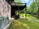 Exterior of home showing wooden deck, surrounding lush greenery and lawn at 880 Havenridge Dr, Conyers, GA 30094