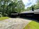 Exterior view of the home and two-car garage with car port at 880 Havenridge Dr, Conyers, GA 30094