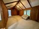 Inviting living room featuring wood-paneled walls, vaulted ceilings, large windows, and cozy seating for relaxation at 880 Havenridge Dr, Conyers, GA 30094