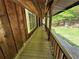 A well-maintained covered porch featuring wood railings and a tranquil view at 880 Havenridge Dr, Conyers, GA 30094