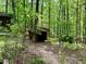 A rustic, open-air shed nestled among the trees, offering storage or a unique outdoor space at 880 Havenridge Dr, Conyers, GA 30094