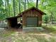 Exterior of shed on property with green door in a wooded area at 880 Havenridge Dr, Conyers, GA 30094