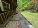A picturesque side yard featuring a well-maintained landscape and charming porch at 880 Havenridge Dr, Conyers, GA 30094