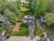 Aerial view of the property showcasing the house, driveway, large backyard, mature trees, and surrounding neighborhood at 2210 Spear Point Dr, Marietta, GA 30062