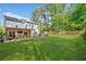 Expansive backyard featuring lush lawn, covered patio, and fenced perimeter at 2210 Spear Point Dr, Marietta, GA 30062