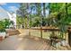 An outdoor wooden deck surrounded by greenery and trees at 2210 Spear Point Dr, Marietta, GA 30062