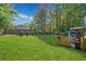 A spacious, well-maintained backyard with lush green grass, a wooden fence, and an outdoor seating area for relaxation at 2210 Spear Point Dr, Marietta, GA 30062