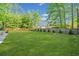 Expansive backyard featuring lush green grass, privacy fence, and mature trees offering a serene outdoor space at 2210 Spear Point Dr, Marietta, GA 30062