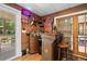Cozy basement bar with wood paneling, custom lighting, and access to a deck at 2210 Spear Point Dr, Marietta, GA 30062