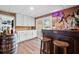 Finished basement bar with white cabinets, wood accents, stools, and sliding glass door to the outside at 2210 Spear Point Dr, Marietta, GA 30062
