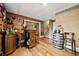 Finished basement bar with wood accents, stools, wood flooring, and access to upstairs at 2210 Spear Point Dr, Marietta, GA 30062