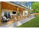 An outdoor covered patio with wood ceiling, ceiling fan, multiple seating areas, and an outdoor television at 2210 Spear Point Dr, Marietta, GA 30062