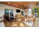 An outdoor covered patio with wood ceiling, ceiling fan, and multiple seating areas at 2210 Spear Point Dr, Marietta, GA 30062