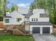 Striking two-story home featuring a two-car garage, a stone foundation, and modern white siding at 2210 Spear Point Dr, Marietta, GA 30062