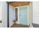 An inviting light blue front door with a side window, welcomes guests into this beautiful home at 2210 Spear Point Dr, Marietta, GA 30062