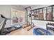 Bright gym space with treadmill, weights, mirrored wall, and natural light at 2210 Spear Point Dr, Marietta, GA 30062