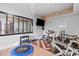 Well-equipped home gym featuring mirrored wall, television, and various exercise equipment at 2210 Spear Point Dr, Marietta, GA 30062