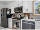 Charming kitchen featuring stainless steel appliances, white cabinets, and stylish backsplash at 2210 Spear Point Dr, Marietta, GA 30062