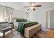 Bright main bedroom featuring a ceiling fan, natural light, hardwood floors, and modern decor at 2210 Spear Point Dr, Marietta, GA 30062