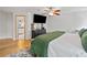 Large main bedroom with hardwood floors, a ceiling fan, modern decor, and ensuite bathroom access at 2210 Spear Point Dr, Marietta, GA 30062