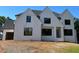 A charming, newly constructed two-story home featuring a white brick facade, black framed windows and an attached garage at 2856 Octavia Cir, Marietta, GA 30062