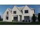 A stylish two-story home with a white brick exterior, complemented by dark framed windows, and green lawn at 2856 Octavia Cir, Marietta, GA 30062