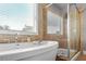 Bright bathroom with a soaking tub beneath a window and a glass-enclosed shower at 365 Freeman Sw Ter, Atlanta, GA 30331