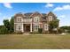 Elegant brick home features a covered porch, balcony, and lush landscaping at 365 Freeman Sw Ter, Atlanta, GA 30331