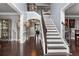 Grand foyer showcasing elegant staircase, rich hardwood floors, and decorative columns at 365 Freeman Sw Ter, Atlanta, GA 30331