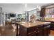 An open concept kitchen features a granite island that is perfect for entertaining, along with dark wood cabinetry at 365 Freeman Sw Ter, Atlanta, GA 30331