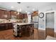 Well-lit kitchen boasts dark wood cabinets, stainless steel appliances, and a granite island with seating at 365 Freeman Sw Ter, Atlanta, GA 30331