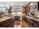 A wide galley kitchen is equipped with stainless steel appliances, a granite countertop, and dark wood cabinets at 365 Freeman Sw Ter, Atlanta, GA 30331