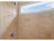 Bright shower with tan tiling, window, and chrome fixtures at 365 Freeman Sw Ter, Atlanta, GA 30331