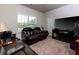 Spacious room with comfortable seating, media center, and natural light from the window at 61 N Village Cir, Rydal, GA 30171