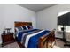 Bedroom features comfortable bed, side table, and a TV at 61 N Village Cir, Rydal, GA 30171